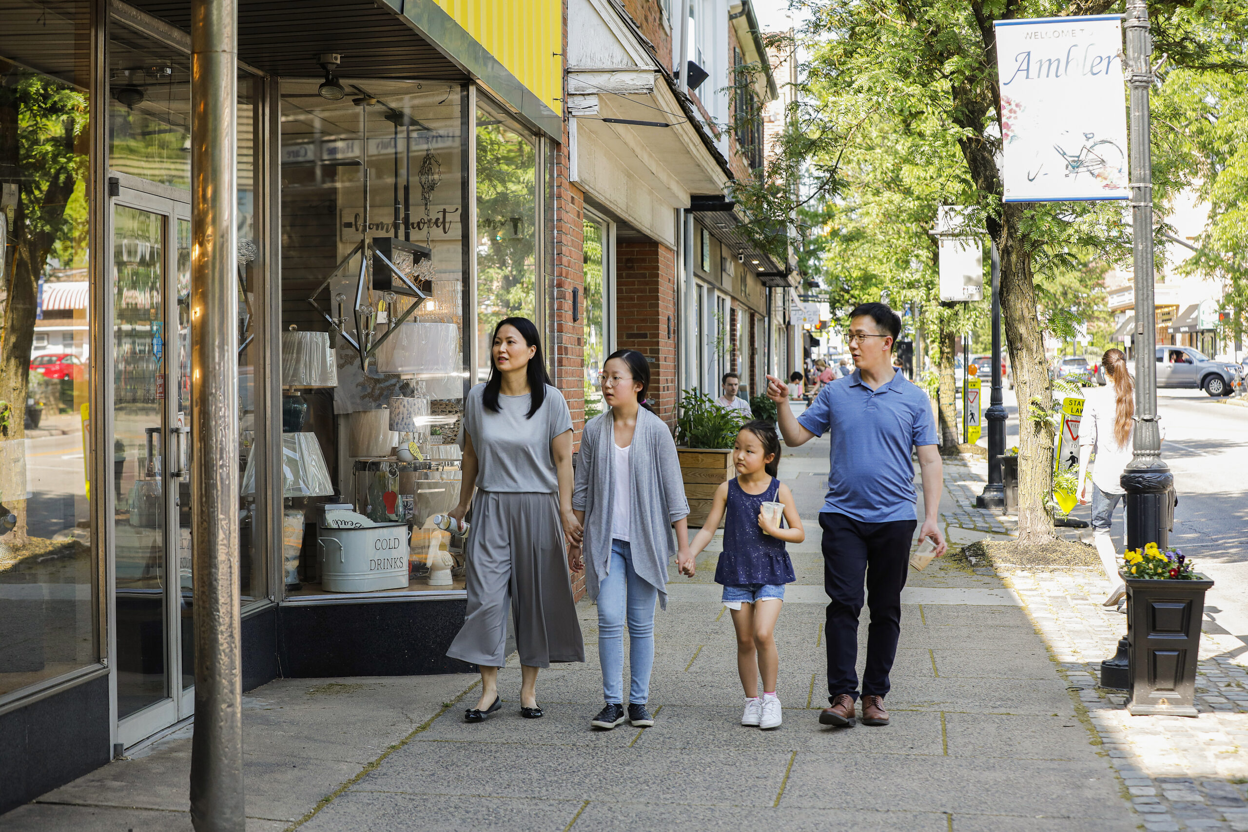 A family of four walks down Butler Avenue in Ambler.