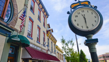 Colorful main street and street clock in Conshohocken.