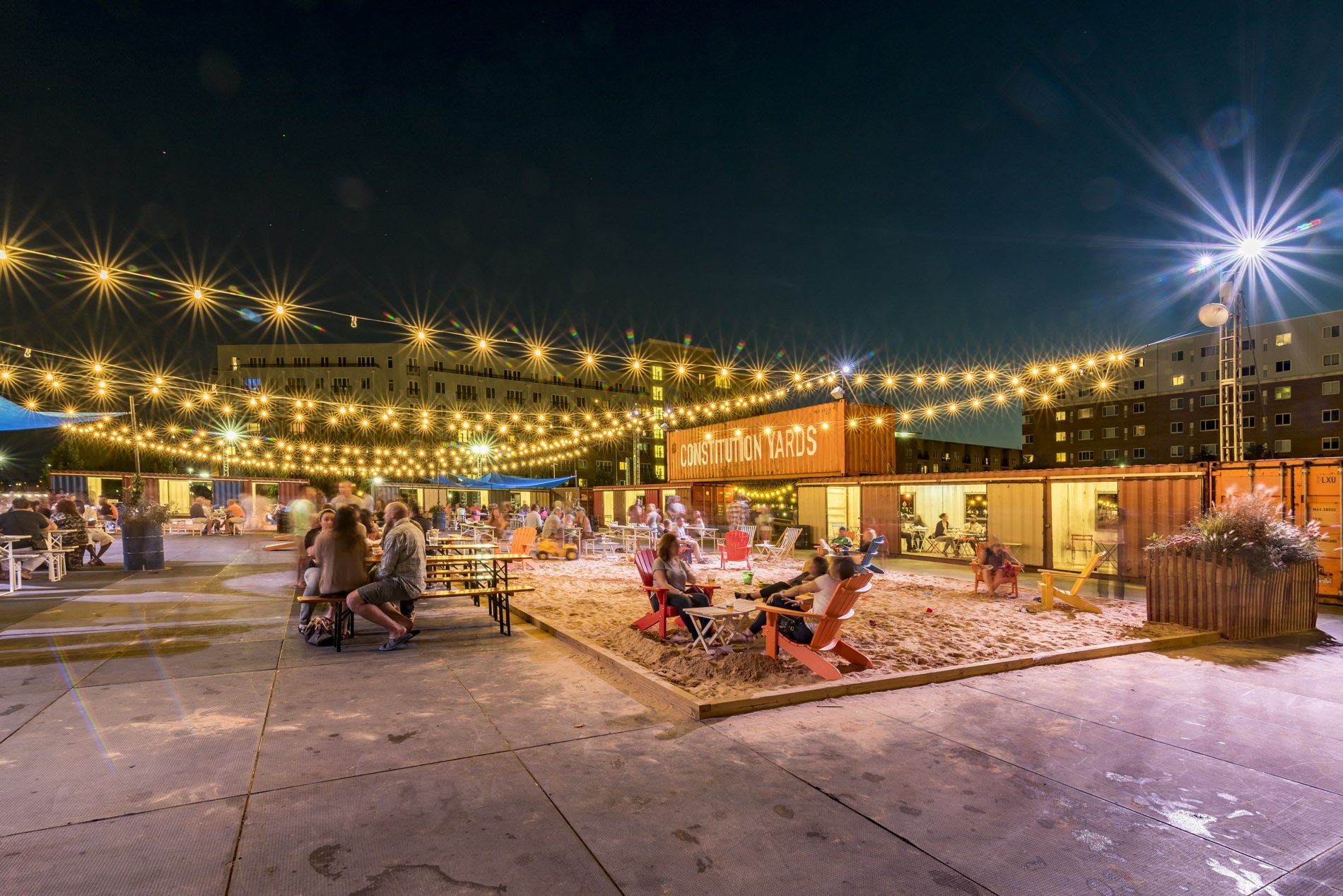 People relaxing outdoors in Constitution Yards.