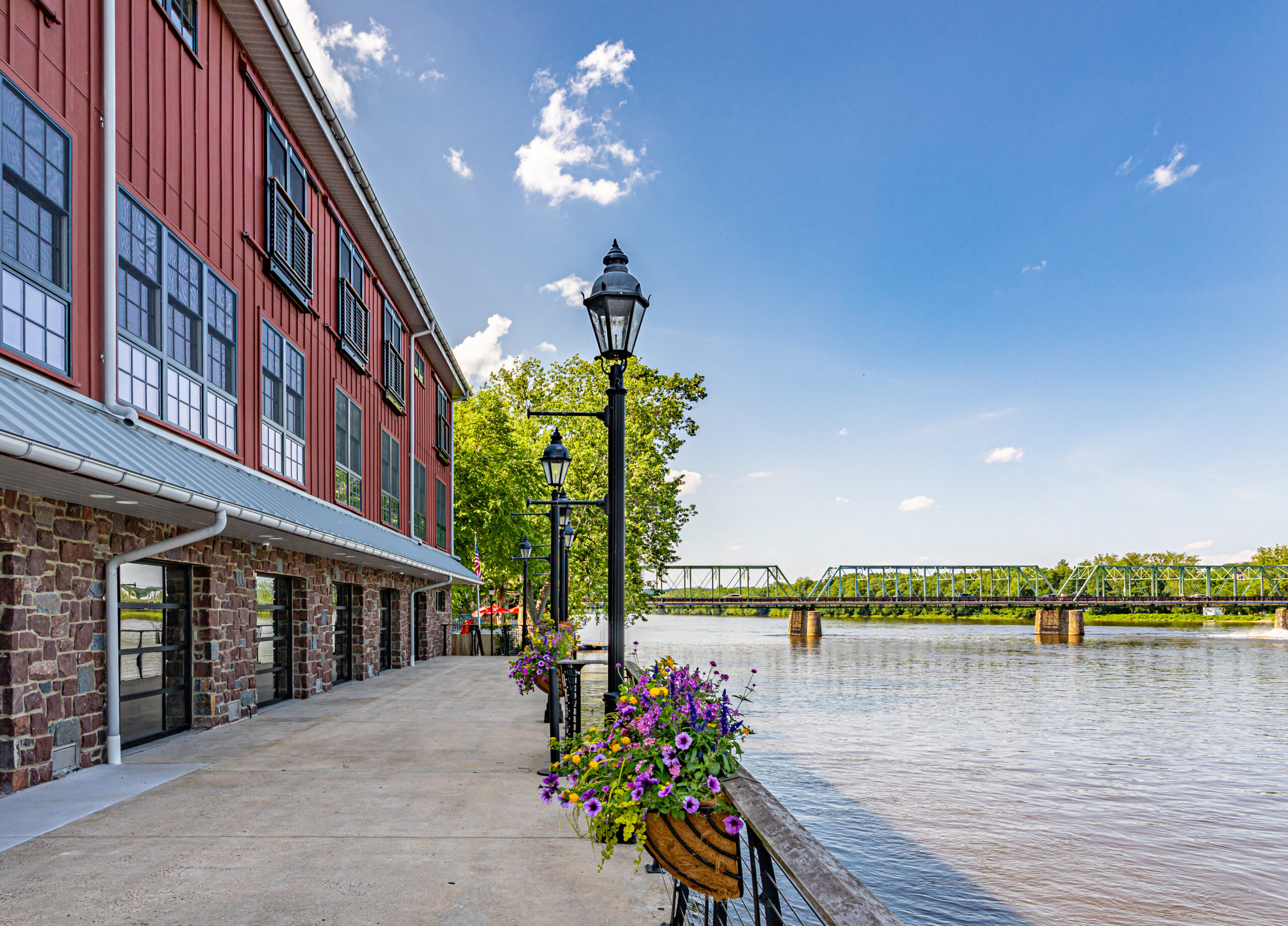 Quaint and colorful inn along a river on a sunny day.