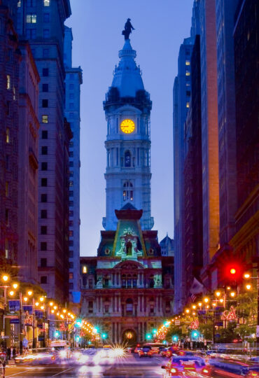 Philadelphia's City Hall lit up at dusk.