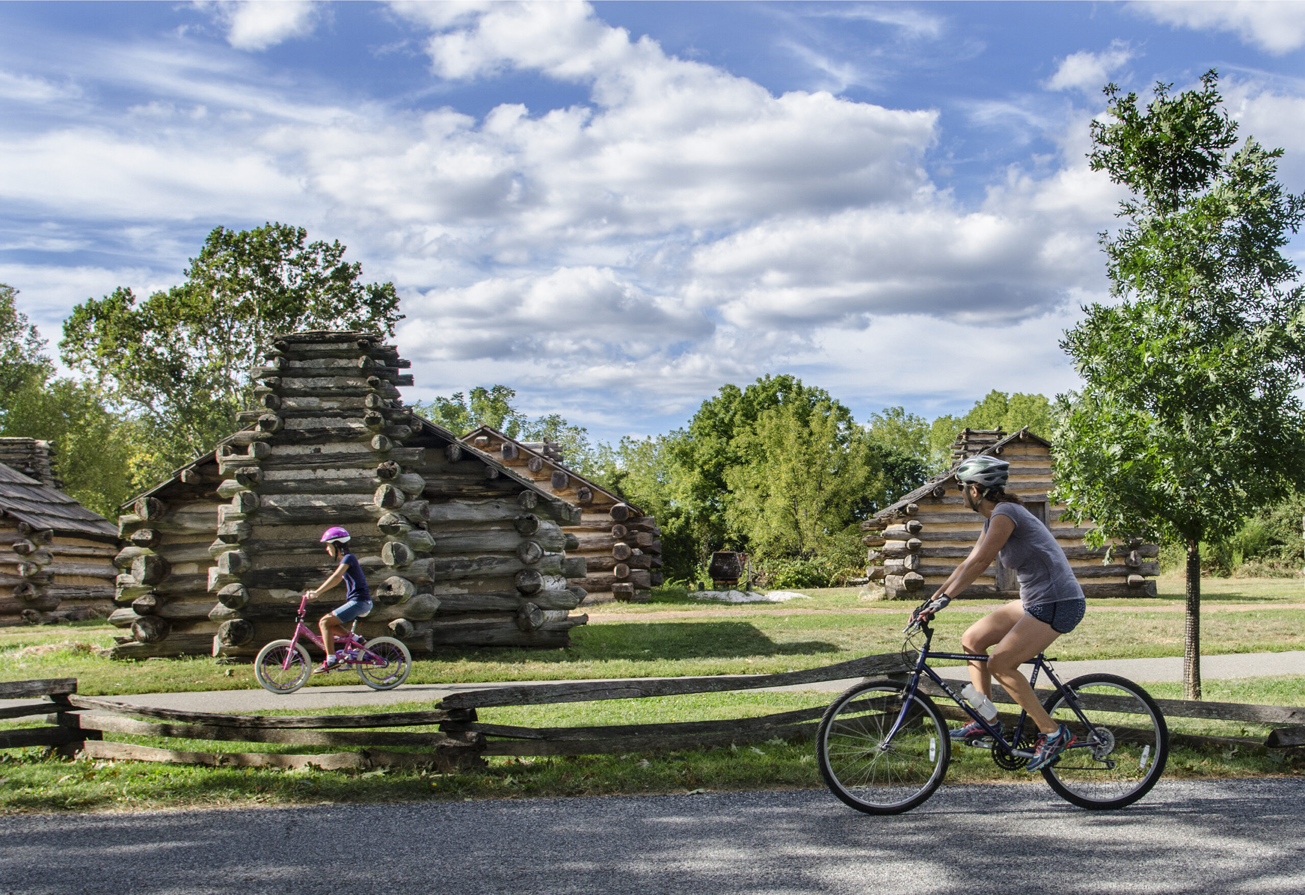 Mother and daughter bike by revolutionary-era forts at Valley Forge.