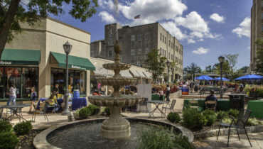 Downtown shopping area with a fountain.