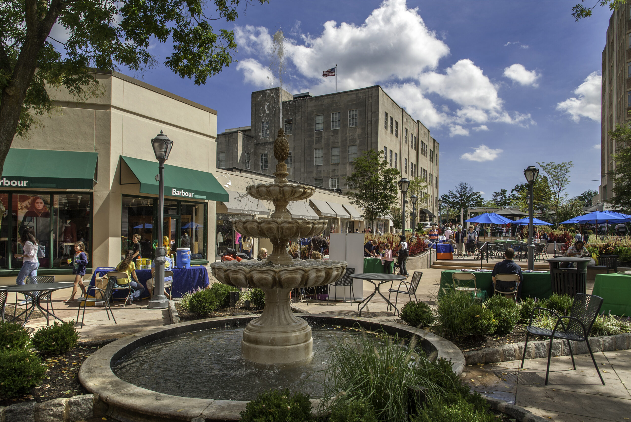 Downtown shopping area with a fountain.